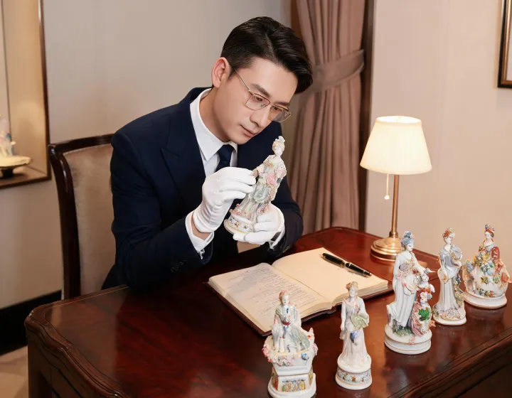 Gift advisor reviewing porcelain figurines
